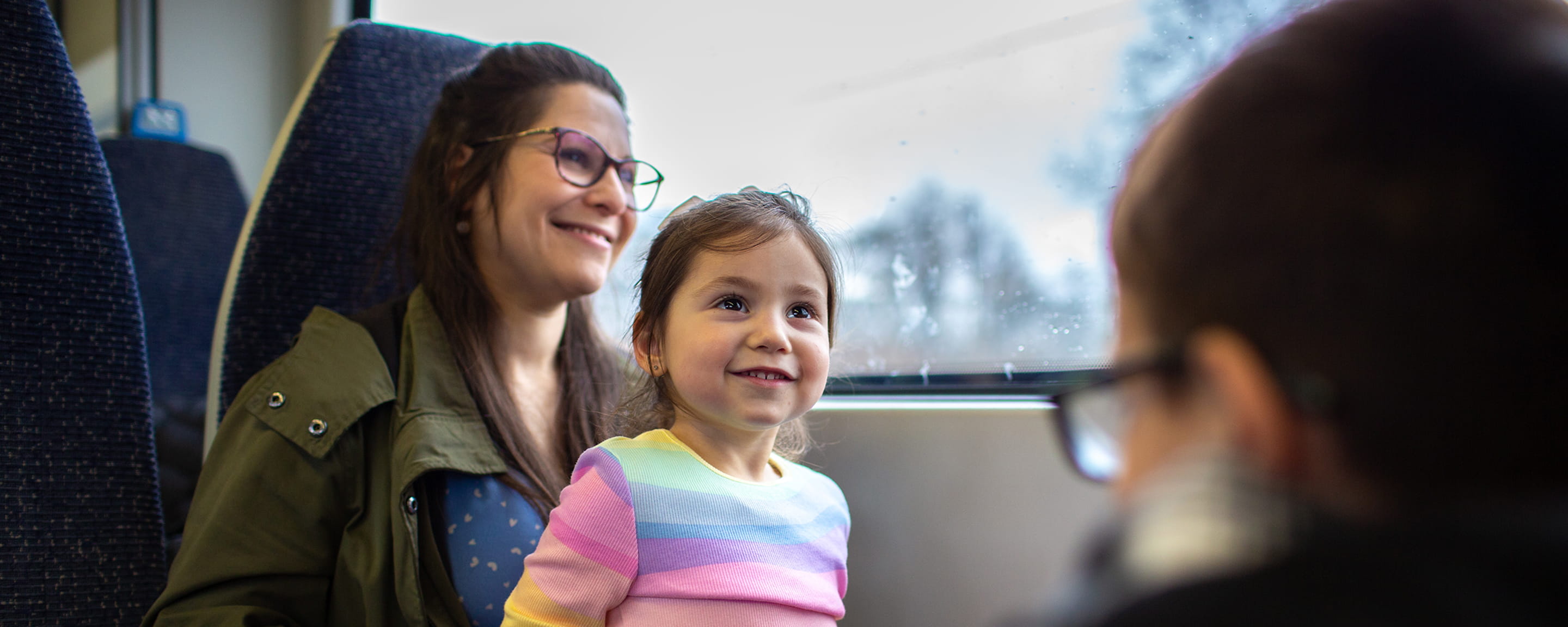A woman and a child sitting in a train
