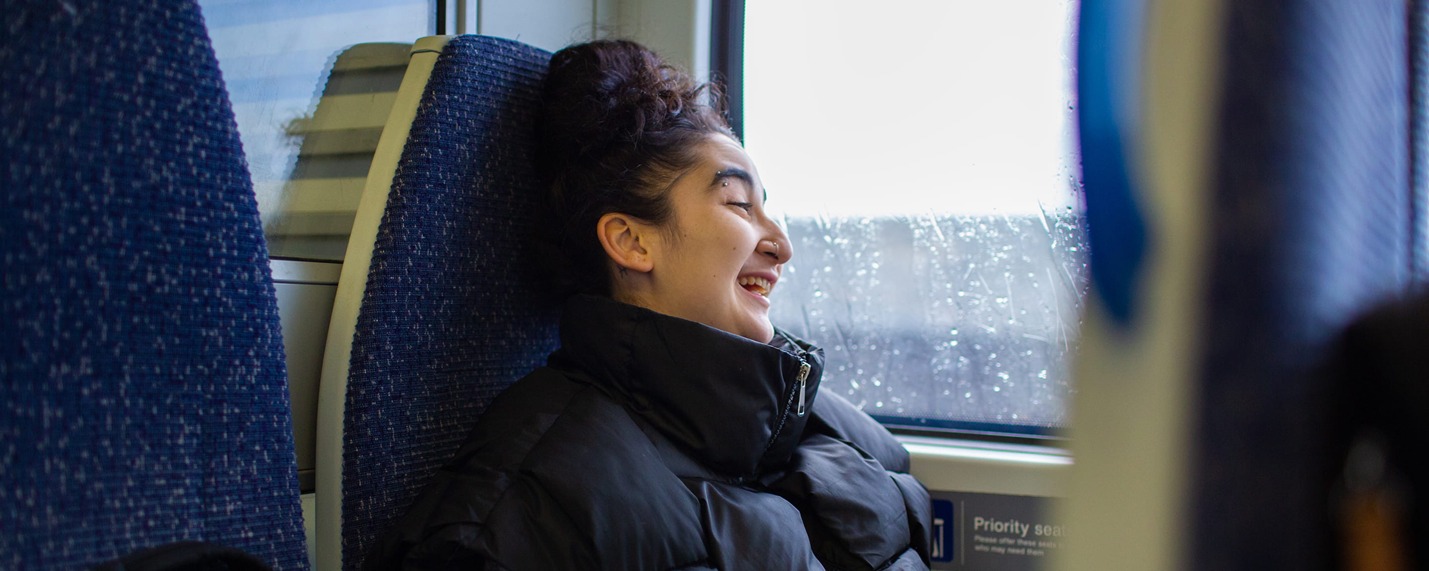 A woman sitting in a train