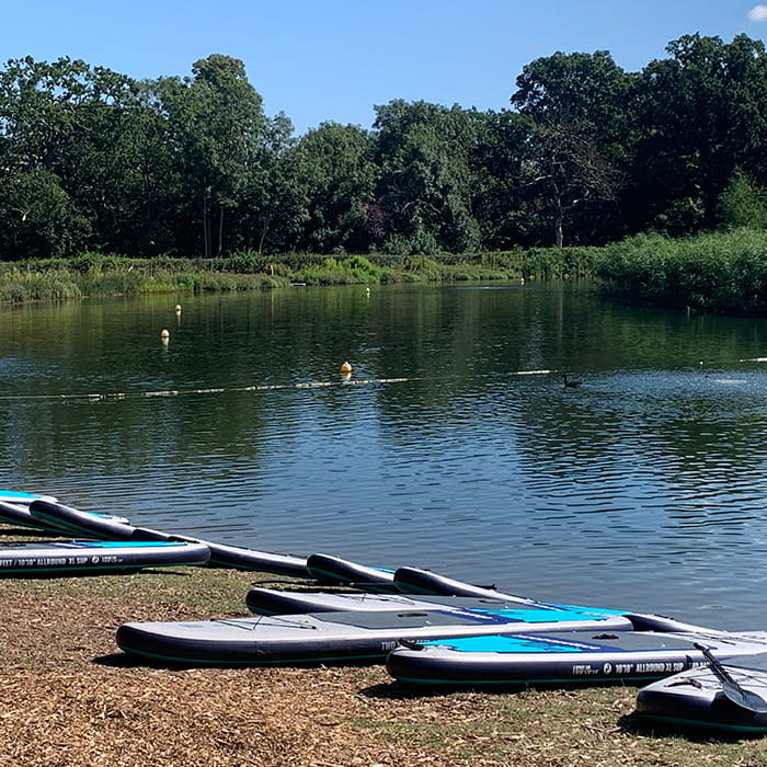 Photo of a lake with water sports items on the shore