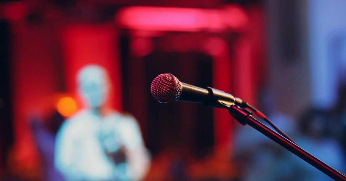Stock image of a microphone on a stage