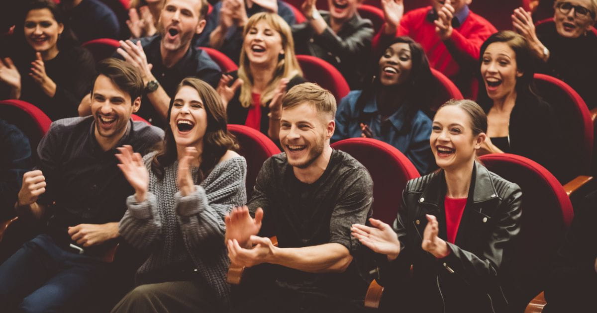 Stock image of an audience laughing at a comedy venue