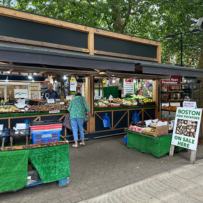 A market stall displaying food and vegetables