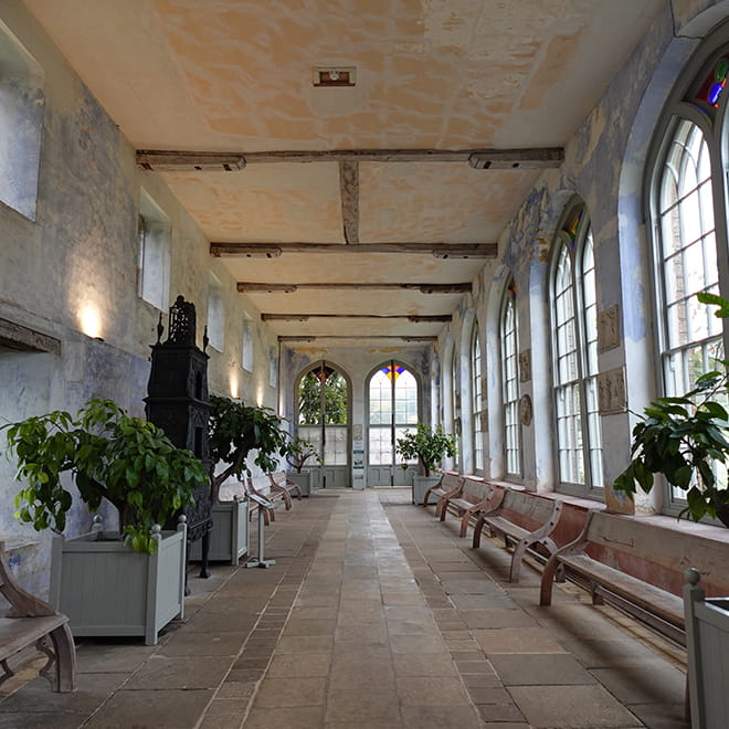 Inside a building with benches and large windows