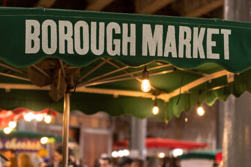 a close up of a green street sign hanging from a pole