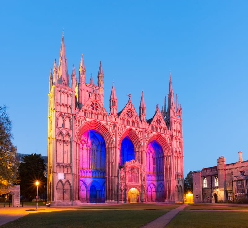 a church with a clock on the side of Peterborough Cathedral