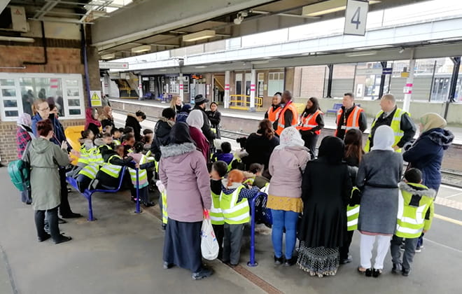 a group of people waiting for their luggage at an airport