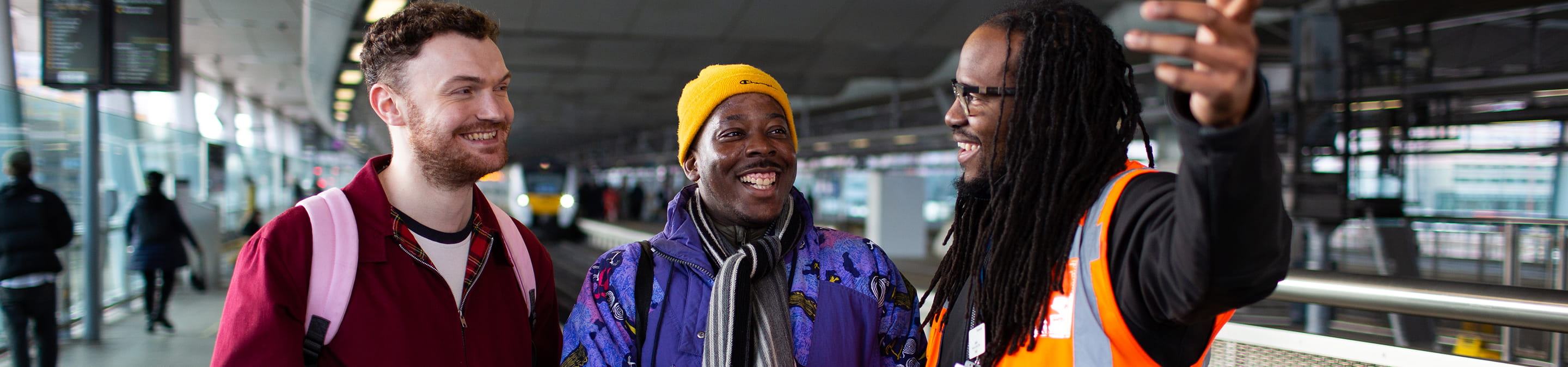 Three people at a train station