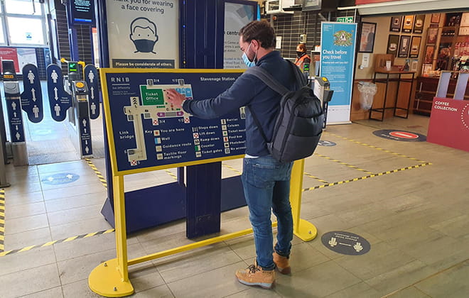 Man standing at a brochure rack