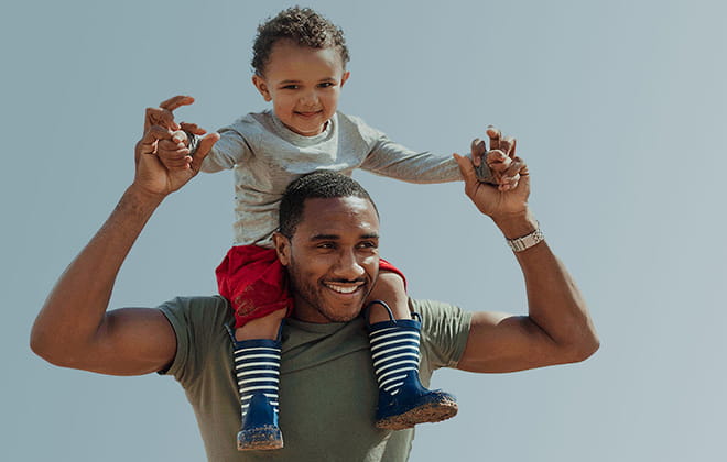 A man with a child on his shoulders