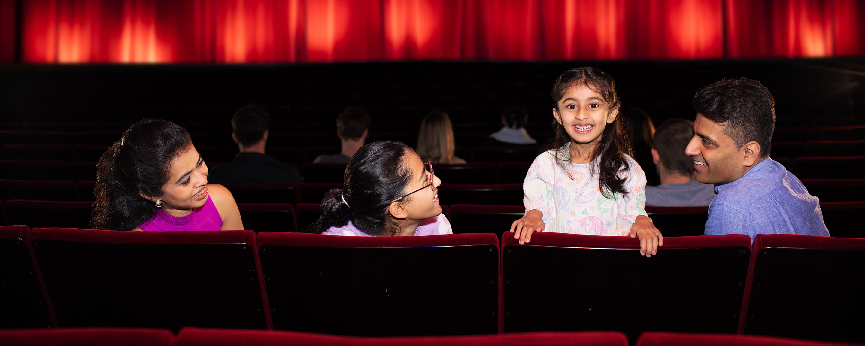 Kids sitting in the audience of a theatre