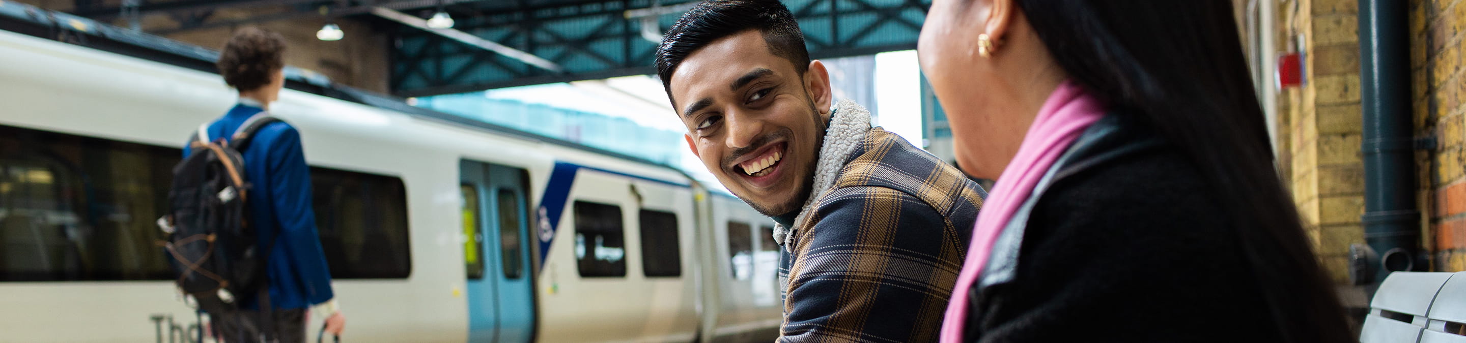 Three people at a train station