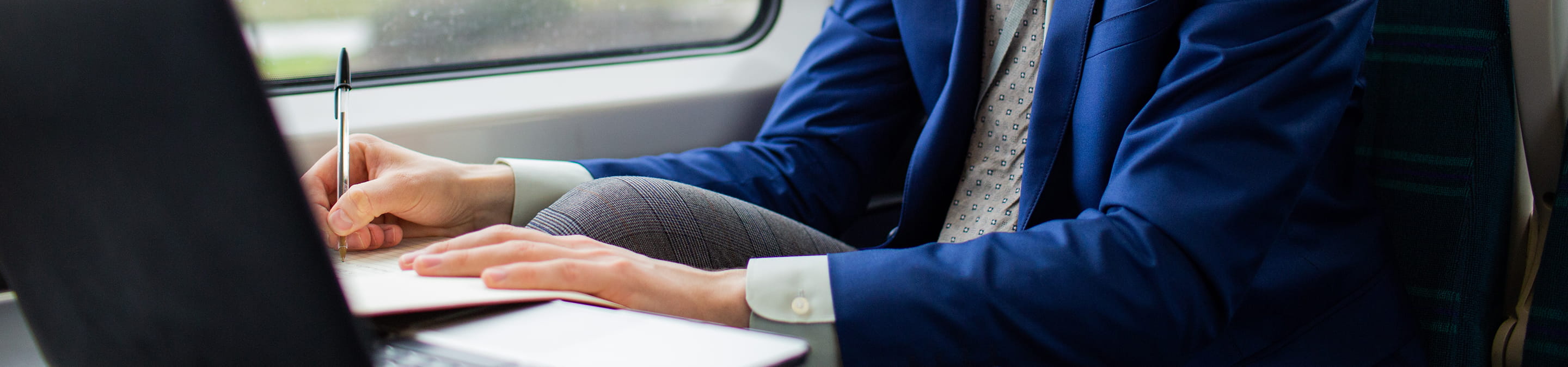 A person using a laptop on a train