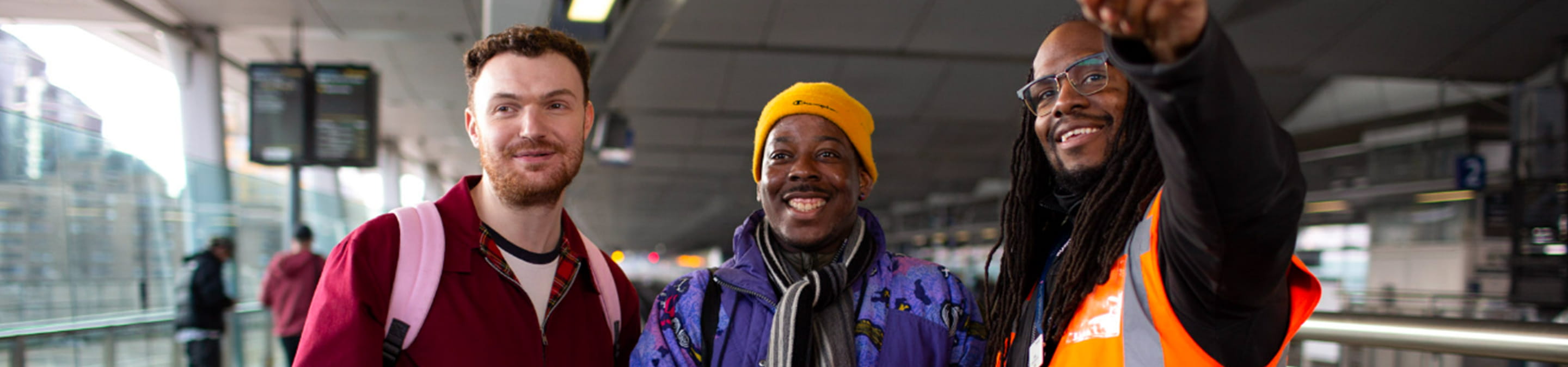 Three people on a train platform