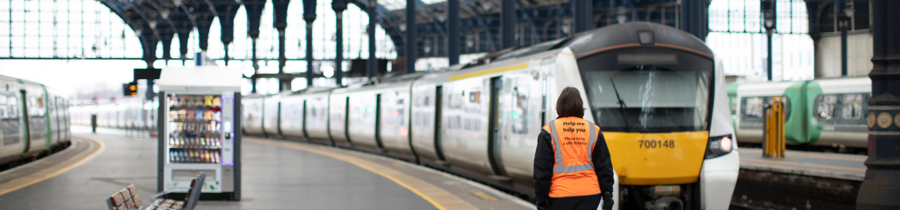 A person standing on a train platform next to a train