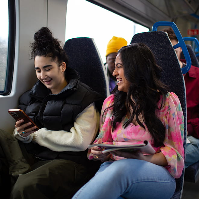 Two people sitting on a train