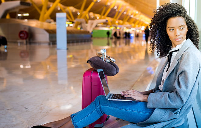 a person sitting on a luggage bag