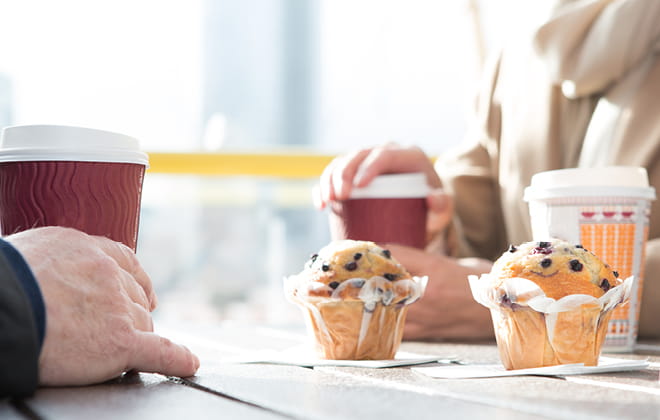 a person sitting at a table with a cup of coffee