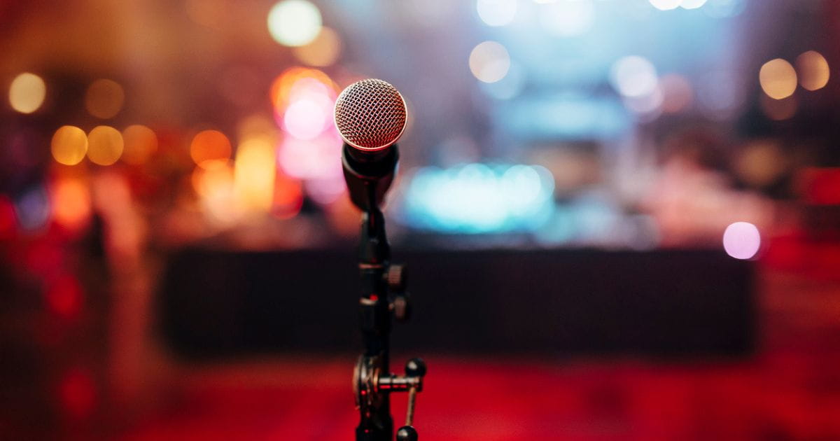 Stock image behind a microphone on stage