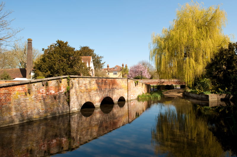 a train crossing a bridge over a body of water
