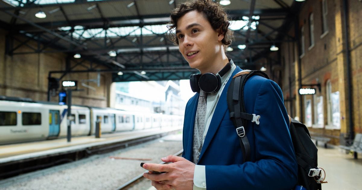 Man in a suit standing on a Thameslink railway station platform