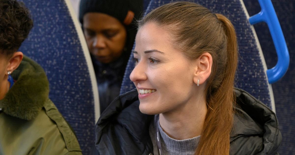 Vanessa smiling on a Thameslink train